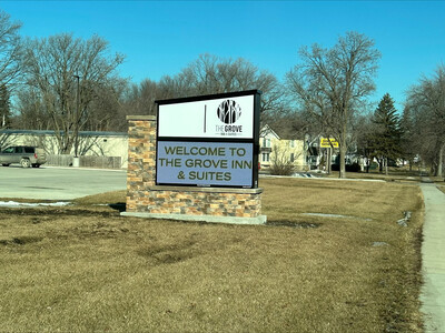 Outdoor welcome sign with a digital message panel on a lawn